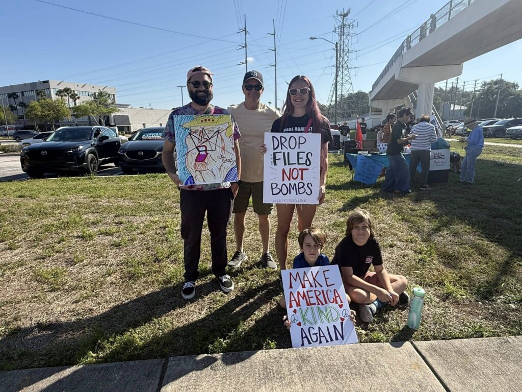 Duke Energy Overpass Bridge, grassroots signs saying drop files not bombs and make america kind again