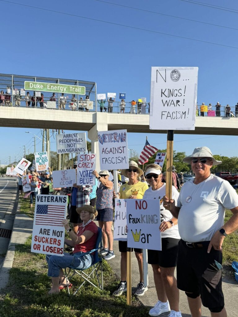 duke energy bridge with citizens in foreground and signs of civic engagement