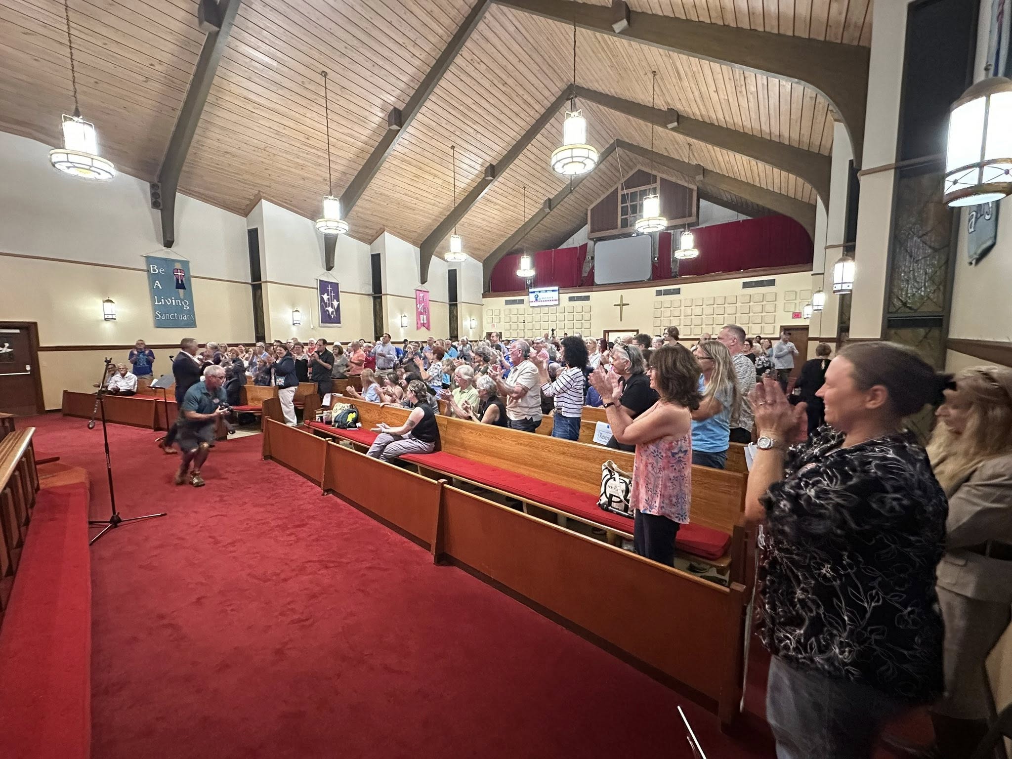 Audience standing and clapping during the David Jolly Town Hall